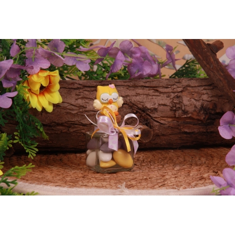 Chouette jaune sur pot en verre